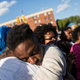 A man hugs a friend after being prayed over April 28, 2015, during a protest near the Baltimore CVS pharmacy that had been set on fire the day before during unrest after the funeral of Freddie Gray. Gray, 25, was arrested April 12, suffered a severe spinal cord injury while in police custody and died a week later.
Andrew Burton/Getty Images